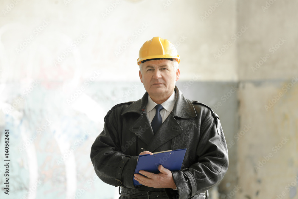 Insurance adjuster in devastated room of abandoned building Insurance adjuster in devastated room of abandoned building