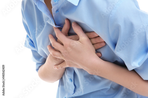 Heart attack concept. Young woman suffering from chest pain on white background