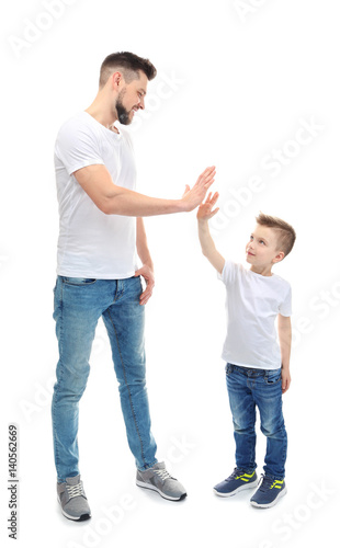 Handsome man with his son on white background