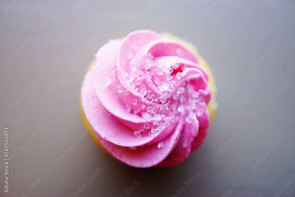 Mini cupcake with pink frosting and sanding sugar on top Mini cupcake with pink frosting and sanding sugar on top