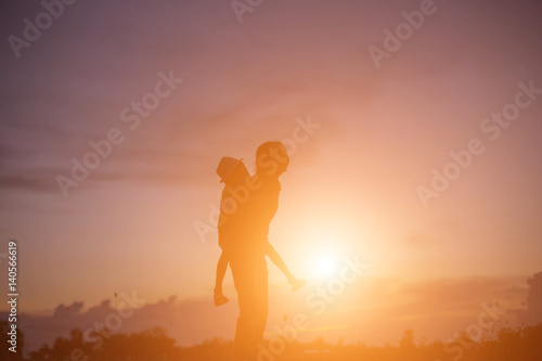 silhouette of a happy children and happy time sunset  © Chittakon