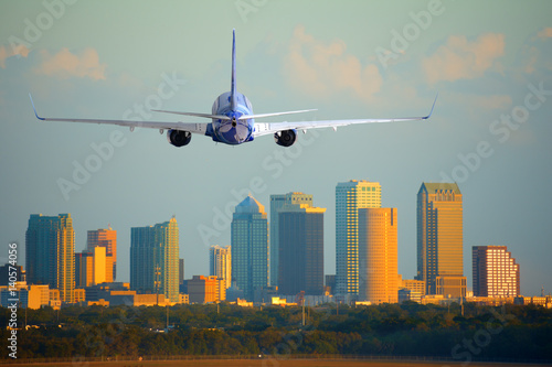Passenger jet airliner plane arriving or departing Tampa International Airport in Florida at sunset or sunrise