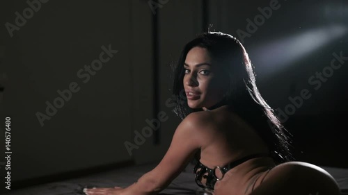 Brunette female posing on bed