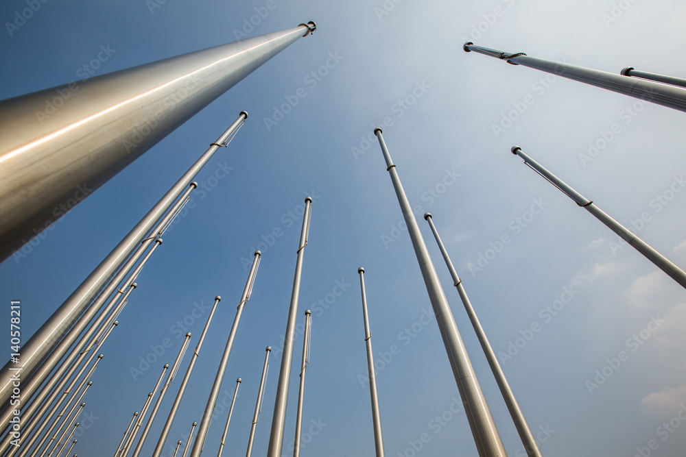 Fototapeta premium Row of flagpole in empty square,Tianjin,China.