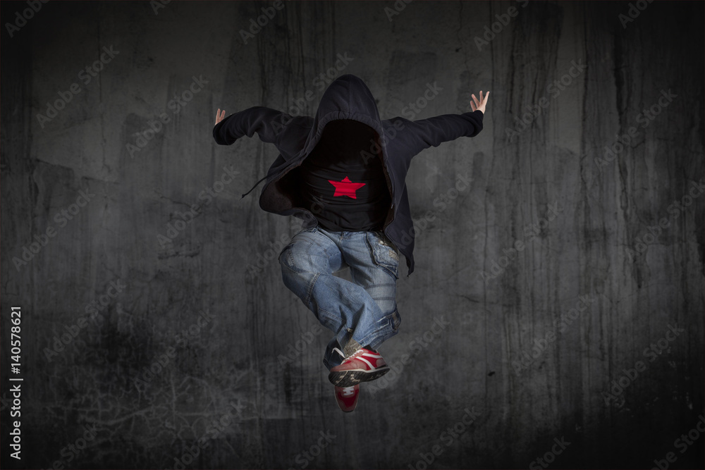 Fototapeta premium Man break dancing on wall background
