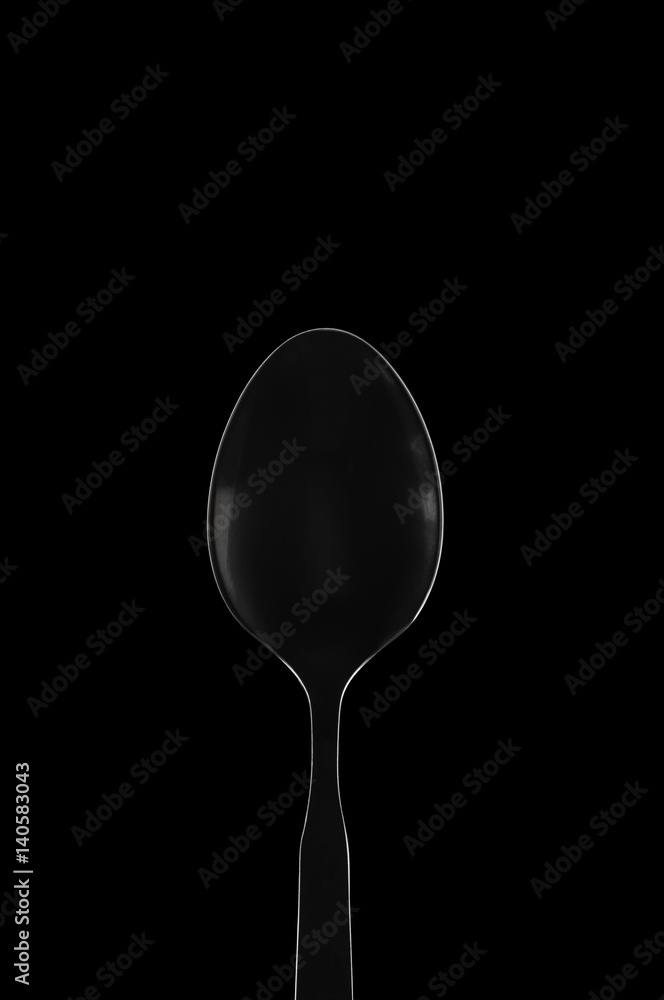 White contour spoon on black background White contour spoon on black background