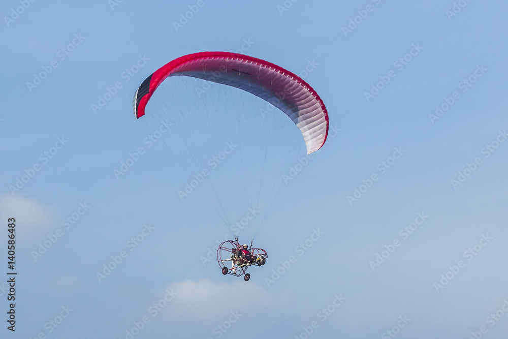 man active extreme sports pilot flying in the sky with paramotor paraglider paraglider motor. man active extreme sports pilot flying in the sky with paramotor paraglider paraglider motor.