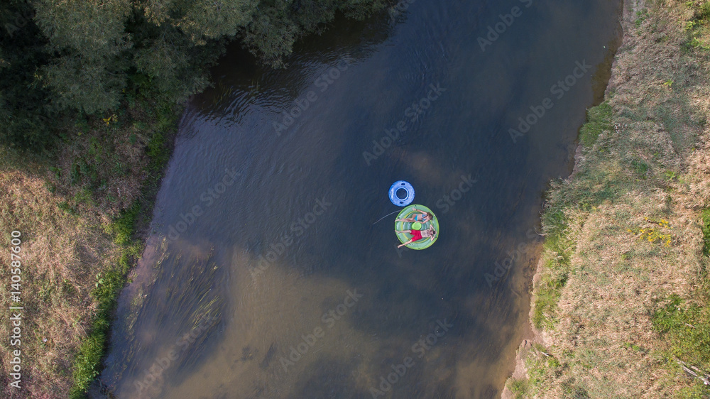 Couple tubing down the river in the summer