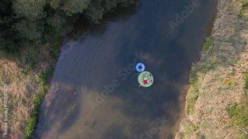 Obraz na płótnie Couple tubing down the river in the summer w salonie