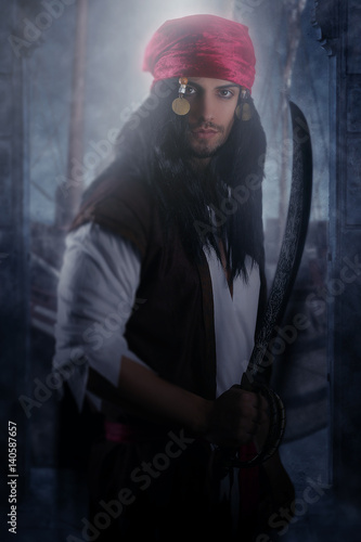 Handsome pirate holding a sword 