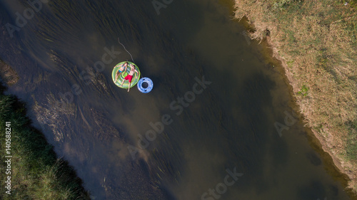 Obraz na płótnie Aerial photo of a couple tubing down the river w salonie