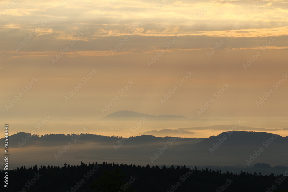Sunrise in the mountains - hills in morning mist Sunrise in the mountains - hills in morning mist