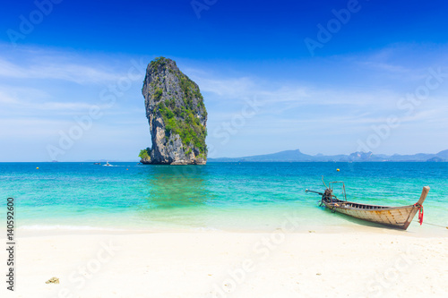 Thailand summer travel sea, Thai old wood boat at sea beach Krabi Phi Phi Island Phuket park on white sand blue sky emerald green ocean water.