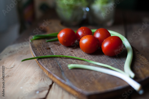 cherry tomatoes, wood background, green onion