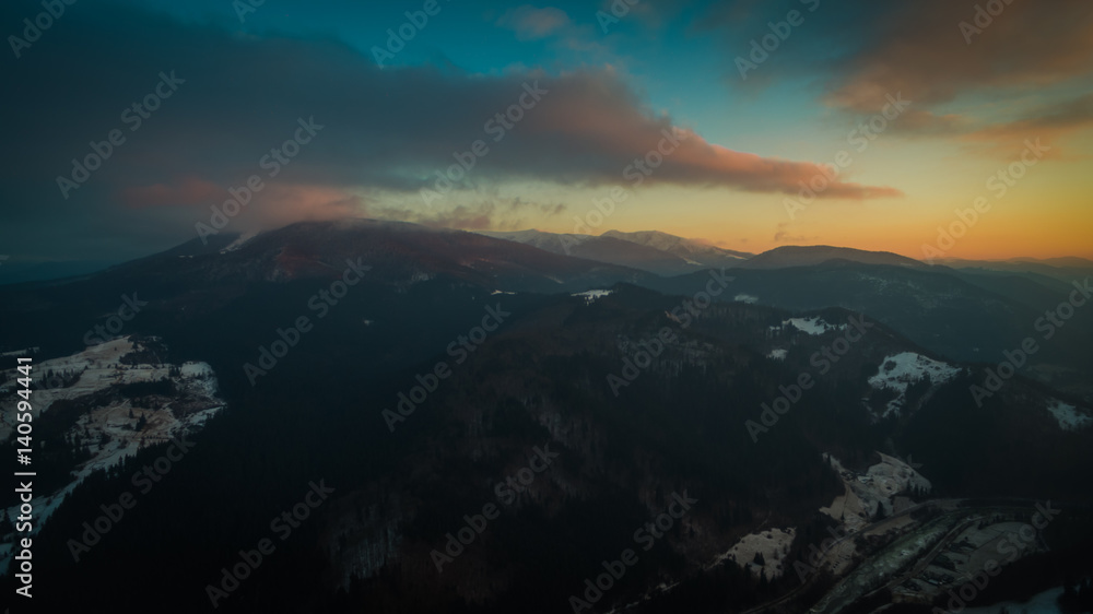 flying in the mountains at sunset. aerial photography