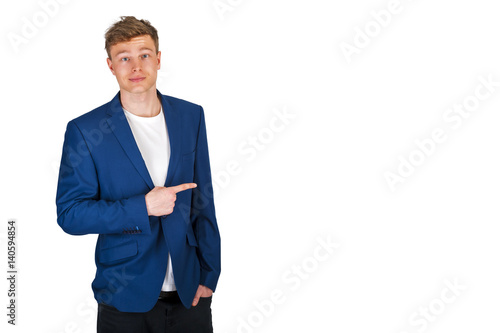Man pointing aside over white background with blue jacket.