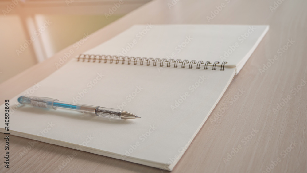 Opened blank notebook with pen on the desk. Opened blank notebook with pen on the desk.