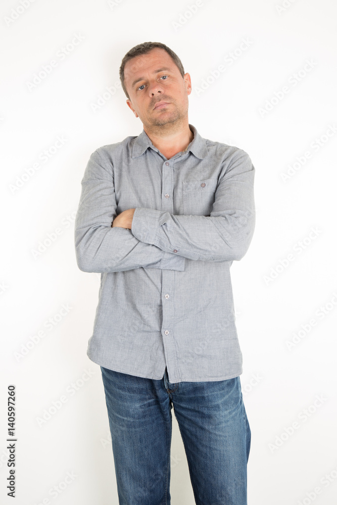 man with a blue shirt and jeans with unhappy crossed arms and sad man with a blue shirt and jeans with unhappy crossed arms and sad