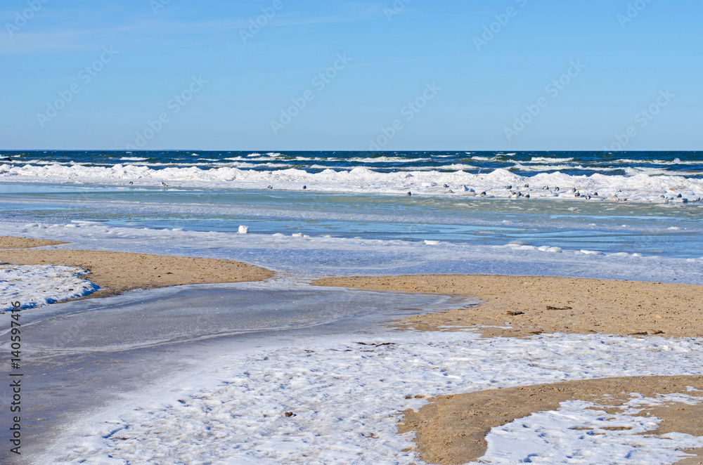 many color shades, shapes and structures of snow, ice and water at the sandy shore of Baltic sea in winter many color shades, shapes and structures of snow, ice and water at the sandy shore of Baltic sea in winter