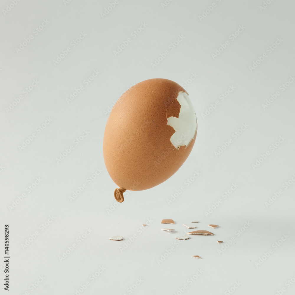 Fototapeta premium Egg balloon on bright white background. Minimal creative concept. Flat lay.