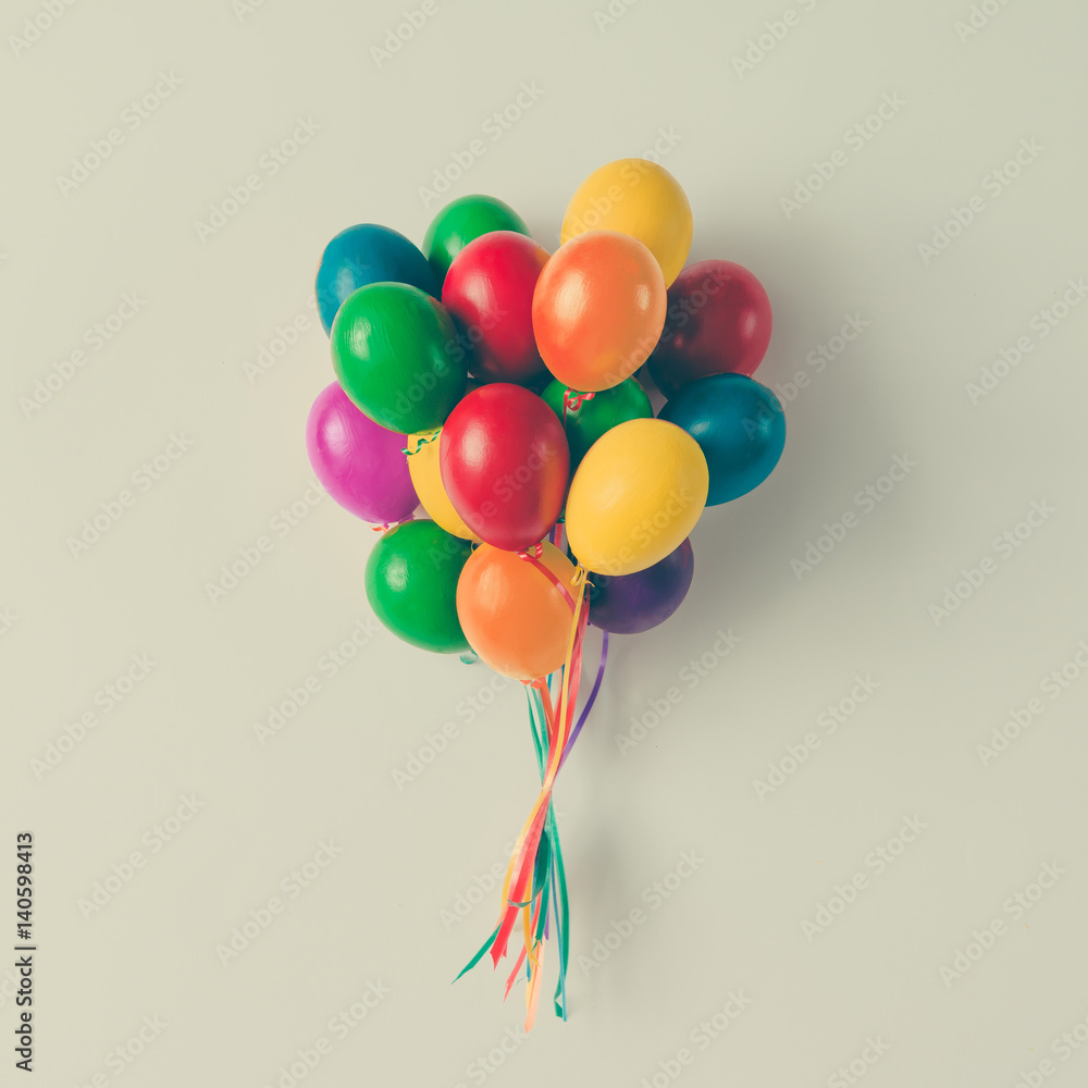 Fototapeta premium Colorful bunch of Easter egg balloons on bright white background. Minimal creative concept. Flat lay.
