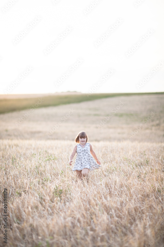 Emotional child on wheat field at sunset,pastel