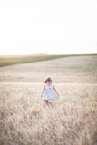 Emotional child on wheat field at sunset,pastel