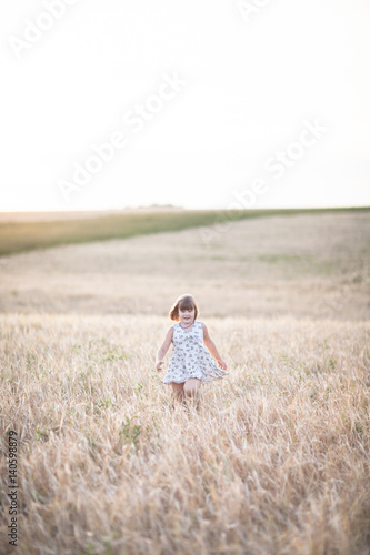 Emotional child on wheat field at sunset,pastel © natalialeb