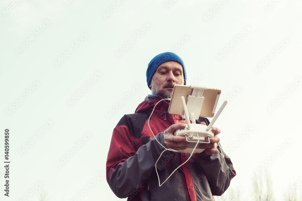Bearded man holds the remote controller in his hands Bearded man holds the remote controller in his hands