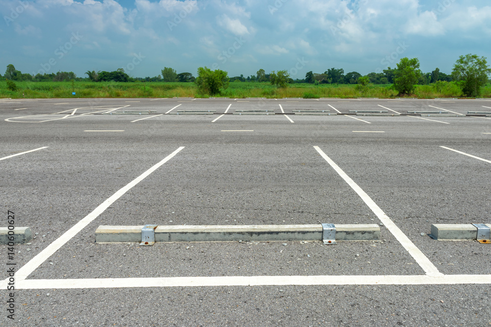 Fototapeta premium Empty parking lot on blue sky background