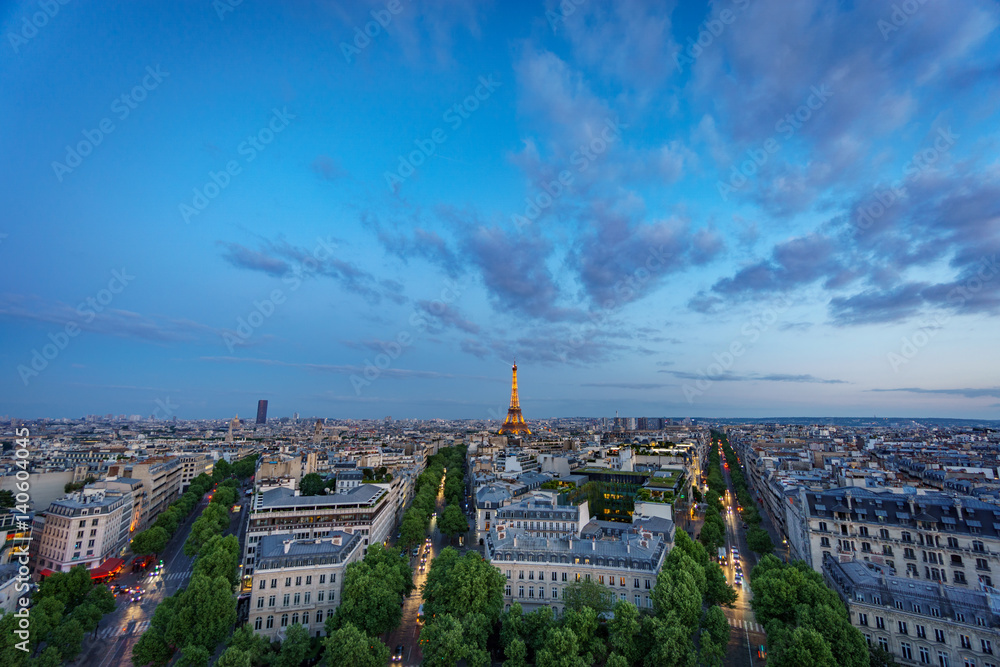 Skyline of Paris with Champs-Elysees and Eiffel tower at sunset