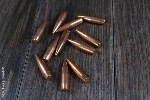 Fototapeta Naklejka Na Ścianę i Meble -  Group of   bullets on dark wooden background