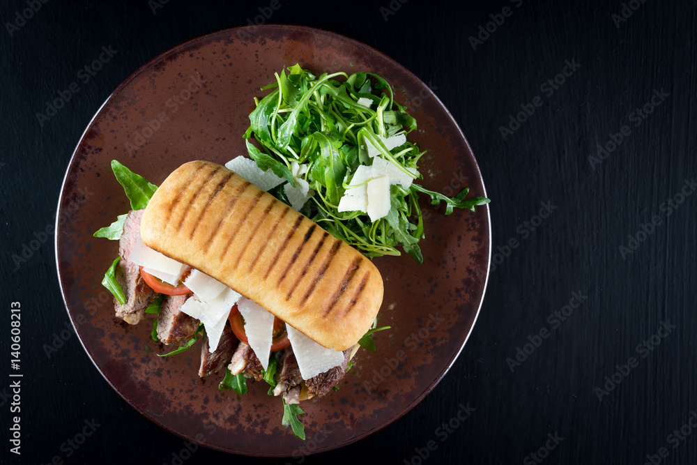 grilled steak medium fresh baked ciabatta sandwich beer