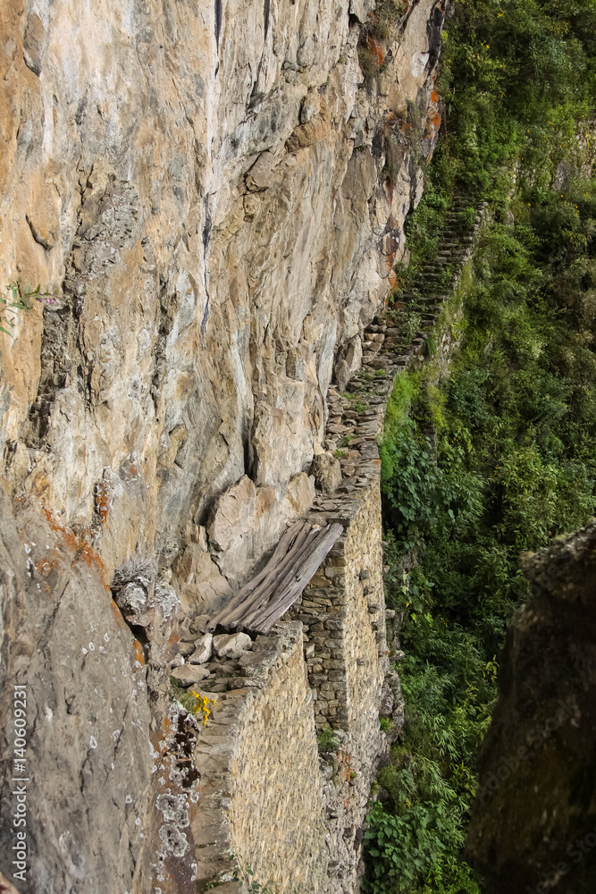 Extreme side view to Inca Drawbridge, Machu Picchu, Unesco World Heritage site, Sacred Valley, Peru 
