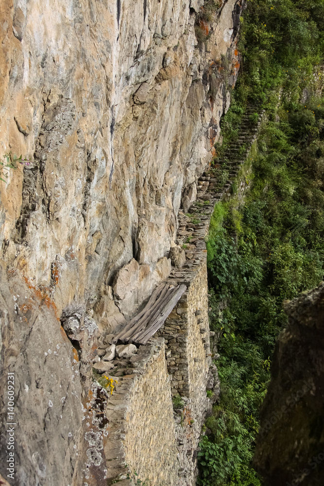 Extreme side view to Inca Drawbridge, Machu Picchu, Unesco World Heritage site, Sacred Valley, Peru Extreme side view to Inca Drawbridge, Machu Picchu, Unesco World Heritage site, Sacred Valley, Peru