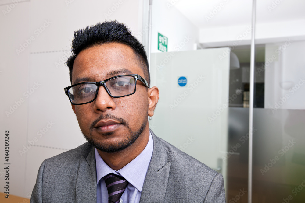 Close-up portrait of Indian Businessman wearing glasses with beard Close-up portrait of Indian Businessman wearing glasses with beard