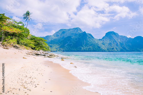 Stunning beach on Helicopter Island in the Bacuit archipelago in El Nido, Cadlao Island in Background, Palawan, Philippines photo