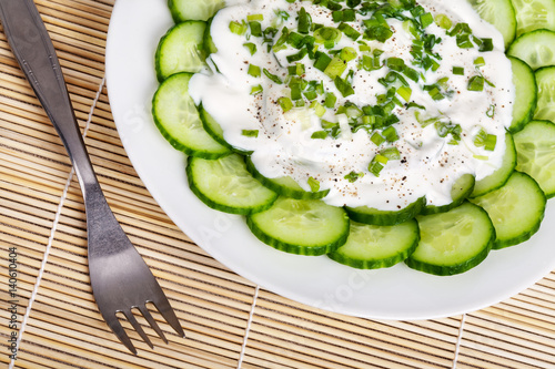 Fresh cucumber slices with sour cream
