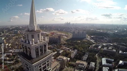 Aerial view of highest Moscow Building Triumph-Palace. Exterior of skyscraper Triumph-Palace against megalopolis at sunny day. House is tallest living building in Europe with high 264,5 meters. photo