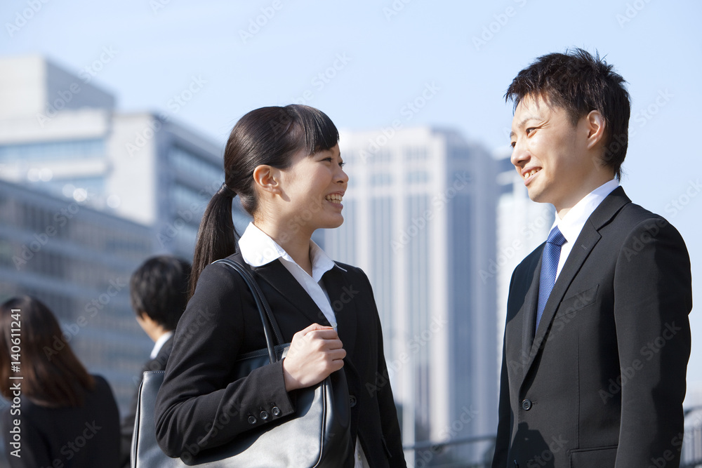 Young Businessman and Businesswoman Looking at Each Other Young Businessman and Businesswoman Looking at Each Other