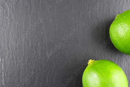 fresh lime fruit on a slate plate food background texture photo