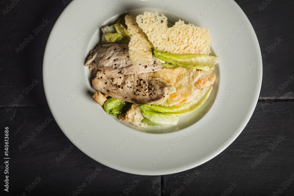 Tasty Caesar salad with chicken. Traditional food. Restaurant Tasty Caesar salad with chicken. Traditional food. Restaurant
