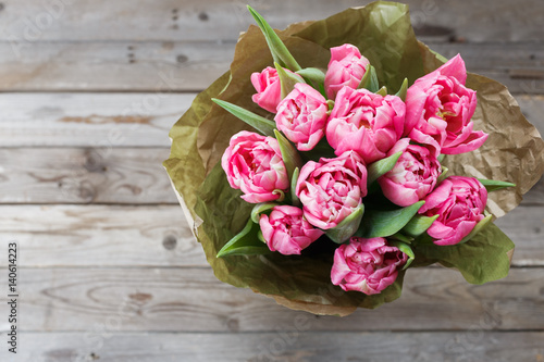 Bouquet of pink peony tulips on a wooden background. Spring flowers. Mother s Day background.