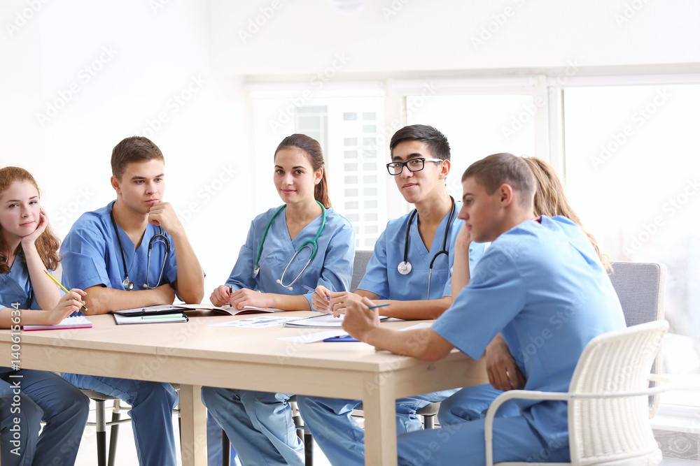 Group of medical students having lecture indoors Group of medical students having lecture indoors