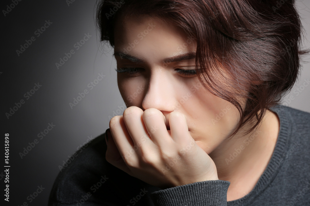 Depressed young woman on grey background, closeup Depressed young woman on grey background, closeup