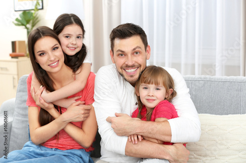 Happy family on sofa in the...