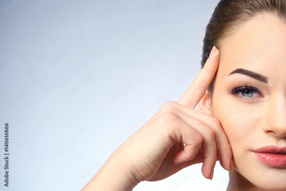 Portrait of beautiful young woman on light background, closeup Portrait of beautiful young woman on light background, closeup