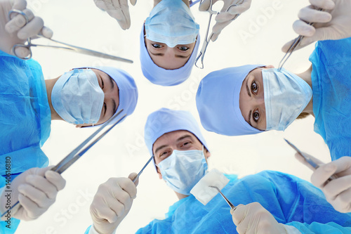 Young doctors with surgical...