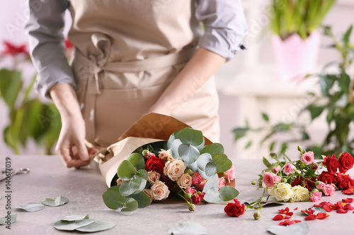 Female florist making beautiful bouquet