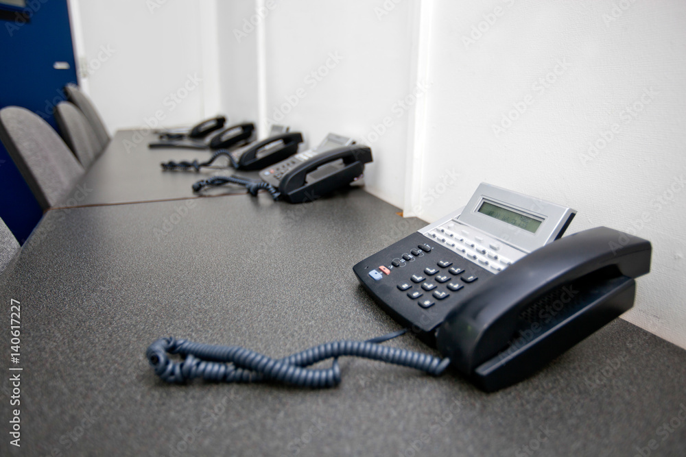 Landline telephones on table in television studio Landline telephones on table in television studio